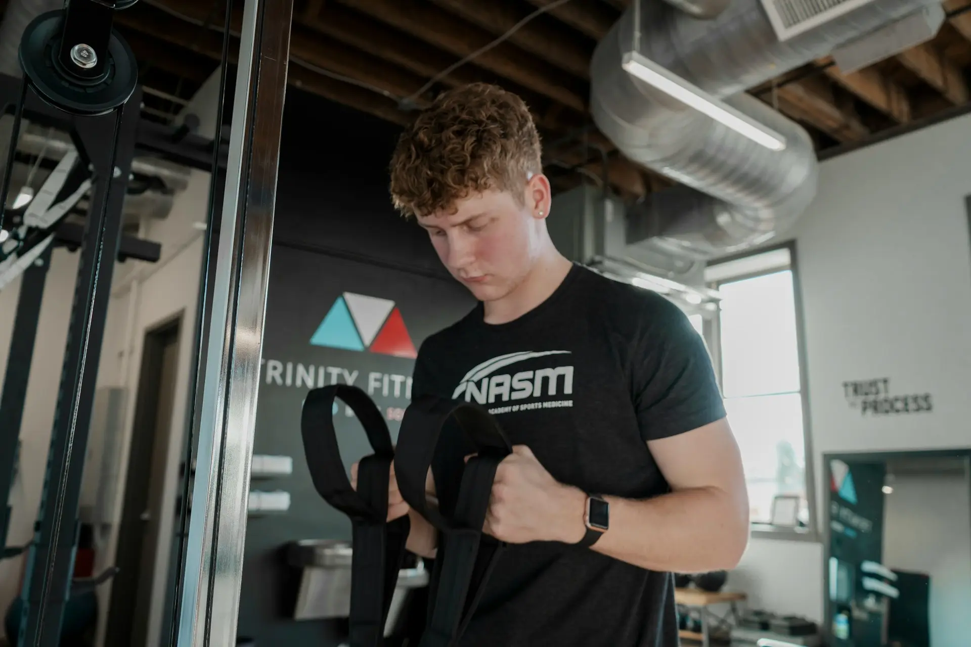 a young man working out with a barbell